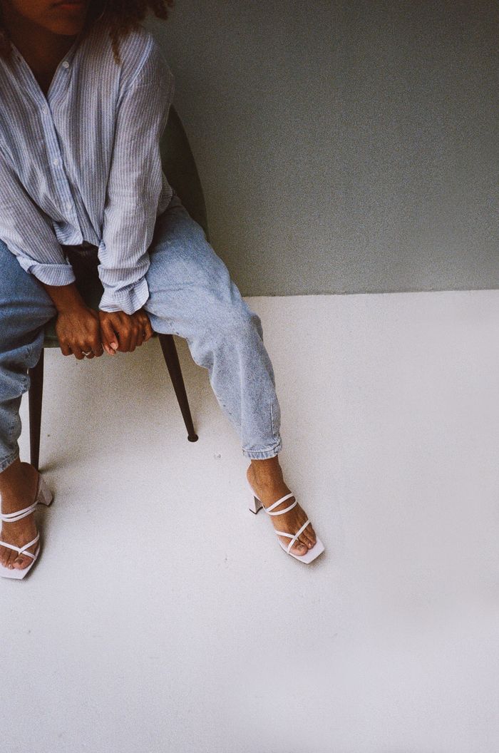 Crafting Captivating Headlines: Your awesome post title goes here Stylish person seated indoors in casual attire, showcasing a relaxed and modern fashion look.